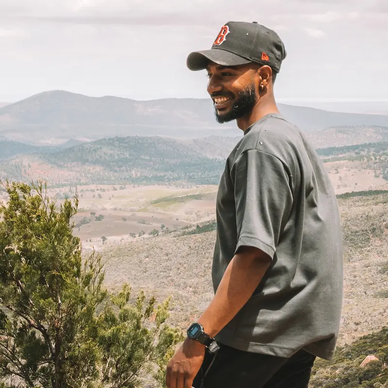 Kas smiling at the top of a hill.