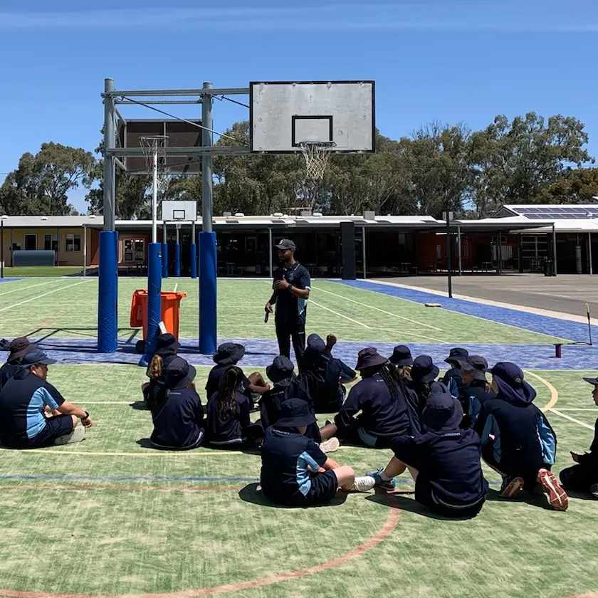 Kas teaching students a PE students outside.